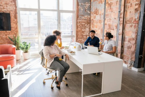 businesspeople eating lunch together in office - junk food stock pictures, royalty-free photos & images
