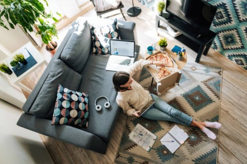 businesswoman eating pizza and studying at home during quarantine - junk food stock pictures, royalty-free photos & images