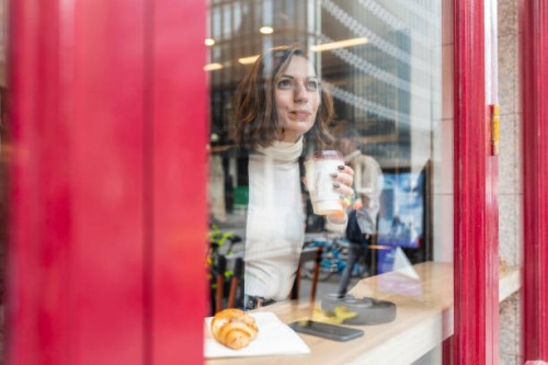 businesswoman having a coffee break at a cafe in the city - junk food stock pictures, royalty-free photos & images
