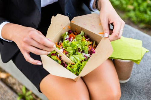 businesswoman having lunch outdoors, partial view - junk food stock pictures, royalty-free photos & images