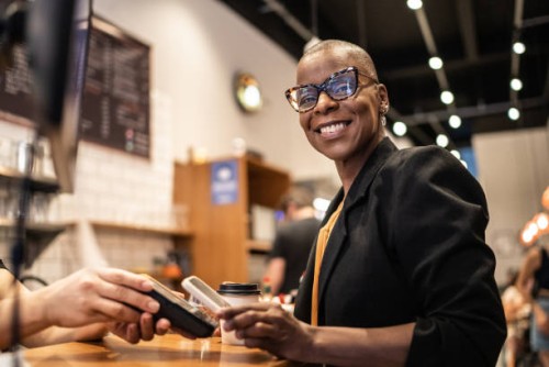 businesswoman paying with qr with mobile in a coffeeshop - junk food stock pictures, royalty-free photos & images