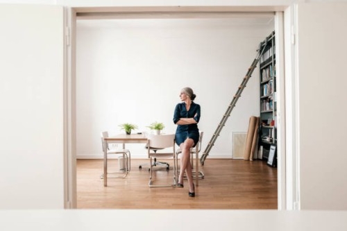 businesswoman sitting in modern office - fashion stock pictures, royalty-free photos & images