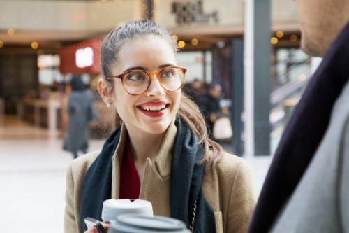 businesswoman walking with colleague through departure lounge. - junk food stock pictures, royalty-free photos & images