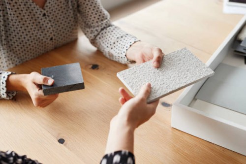 businesswomen holding samples over table in office - home decoration stock pictures, royalty-free photos & images