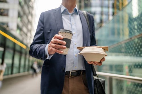 busy business professional enjoying takeout coffee and lunch while navigating the streets of sydney during a workday - junk food stock pictures, royalty-free photos & images