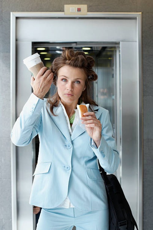 busy businesswoman eating on the go - junk food stock pictures, royalty-free photos & images
