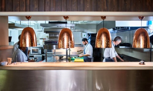 busy chefs working in commercial kitchen - food stockfoto's en -beelden