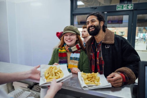 buying fish and chips - junk food stock pictures, royalty-free photos & images