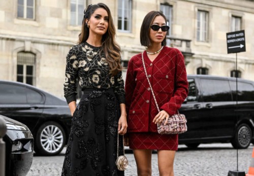 Camila Coelho and Aimee Song are seen wearing Chanel black and red outfits with Chanel bags outside the Chanel show during the Womenswear...