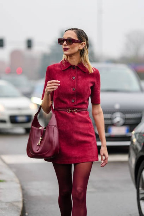 Candela Pelizza wears burgundy bordeaux sunglasses, gold earrings, burgundy bordeaux buttoned short sleeve suede dress, burgundy bordeaux Gucci...