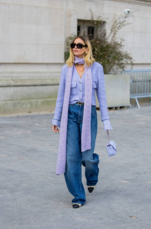 Candela Pelizza wears lavender jacket, scarf, boyfriend style jeans outside Chanel during Womenswear Spring/Summer 2025 as part of Paris Fashion Week...