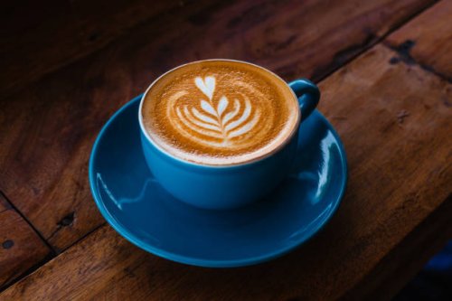 cappuccino in a blue ceramic mug on a wooden table side view - coffee stock pictures, royalty-free photos & images