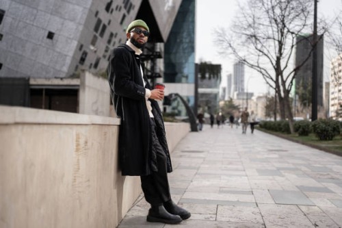 carefree calm black man near modern building with cup of coffee good morning free from work and duty - fashion stock pictures, royalty-free photos & images