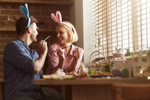 carefree couple having fun on easter in dining room. - home decoration stock pictures, royalty-free photos & images
