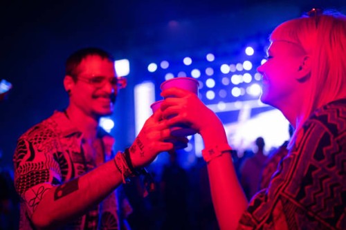 carefree couple toasting during a music concert at night. - concert stock pictures, royalty-free photos & images
