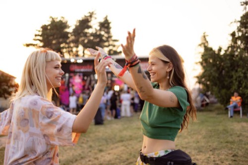 carefree female friends dancing on a music festival. - concert stock pictures, royalty-free photos & images