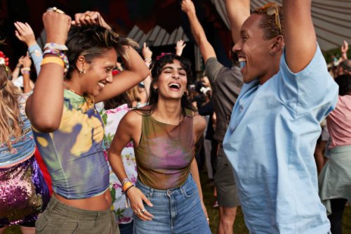 carefree festival goers dancing while enjoying at concert - concert stock pictures, royalty-free photos & images