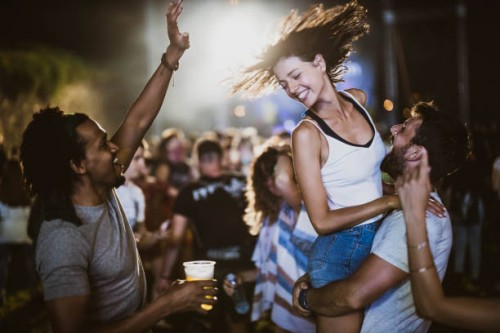 carefree friends having fun on music festival by night. - concert stock pictures, royalty-free photos & images