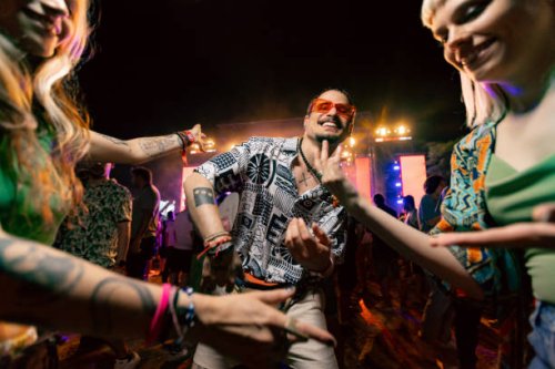 carefree man dancing with his friends on music concert by night. - concert stock pictures, royalty-free photos & images