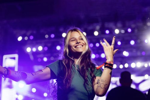 carefree woman having fun while dancing on a music festival at night. - concert stock pictures, royalty-free photos & images