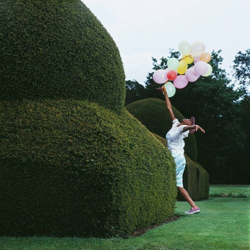 carefree woman with balloons - garden decoration stock pictures, royalty-free photos & images