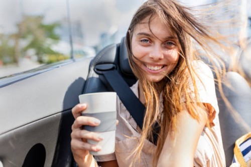 careless, young and happy woman is holding recycable takeaway coffee cup - junk food stock pictures, royalty-free photos & images