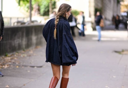 Carla Ginola is seen wearing a denim Zimmermann dress and brown knee high boots outside the Zimmermann show during Womenswear Spring/Summer 2025 as...