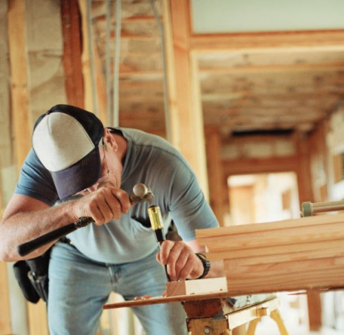 carpenter chiseling out wood at home renovation site - home decoration stock pictures, royalty-free photos & images