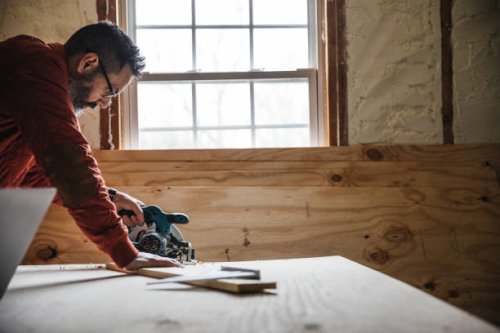 carpenter cutting a piece of plywood - home decoration stock pictures, royalty-free photos & images