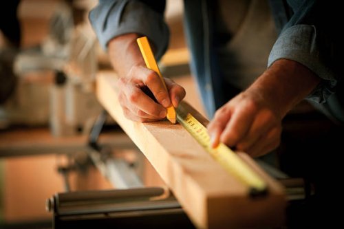 carpenter measuring a wooden plank - home decoration stock pictures, royalty-free photos & images