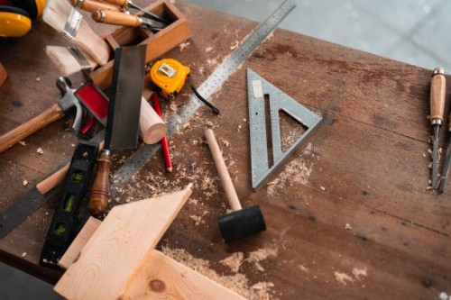 carpenter tools,hammer,meter,nails,shavings, and chisel over wood table - home decoration stock pictures, royalty-free photos & images