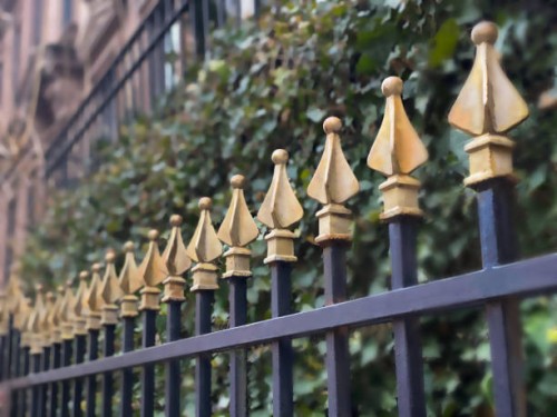 cast iron fence topped with traditional decorative gold finials - garden decoration stock pictures, royalty-free photos & images