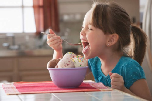 caucasian girl eating bowl of ice cream - junk food stock pictures, royalty-free photos & images