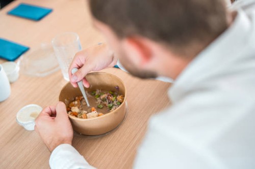 caucasian male eating take out in corporate office - junk food stock pictures, royalty-free photos & images