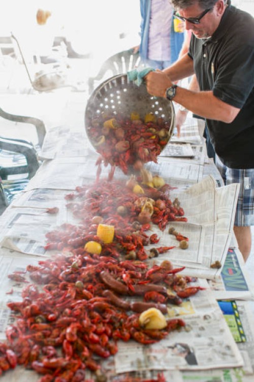 caucasian man serving crawfish at boil - food stock pictures, royalty-free photos & images