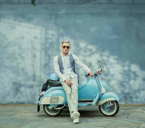 caucasian man sitting on vintage scooter - fashion stock pictures, royalty-free photos & images