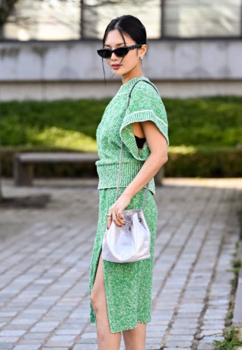 Chailee Son is seen wearing a green Stella McCartney sweater and skirt, silver bag and black sunglasses outside the Stella McCartney show during the...
