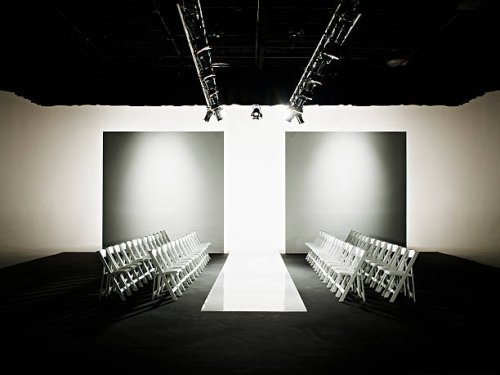 chairs around catwalk set for fashion show - fashion week stock pictures, royalty-free photos & images