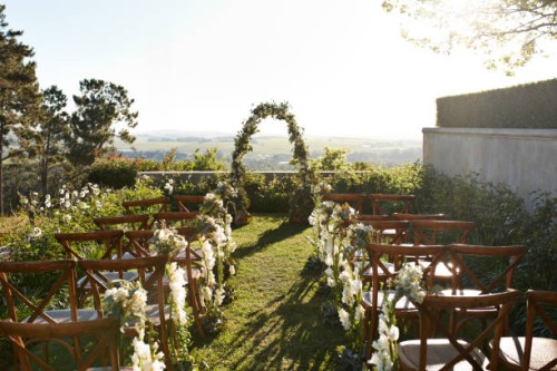 chairs decorated with flowers arranged near wedding altar - garden decoration stock pictures, royalty-free photos & images