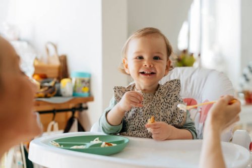 cheerful baby girl eating meal with mother - food stock pictures, royalty-free photos & images