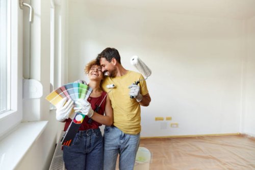 cheerful couple having fun during home renovation process. - home decoration stock pictures, royalty-free photos & images
