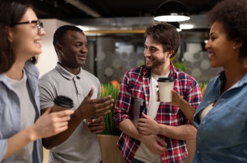 cheerful diverse colleagues chatting during coffee break - junk food stock pictures, royalty-free photos & images