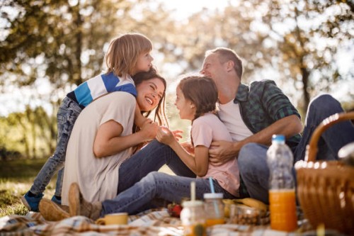 cheerful family having fun on a picnic in spring day. - food stockfoto's en -beelden