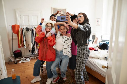 cheerful female friends gesturing while taking selfie - fashion photos et images de collection