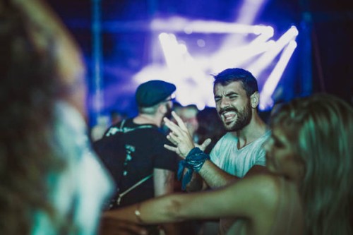 cheerful friends dancing and singing on a music festival by night. - concert stock pictures, royalty-free photos & images