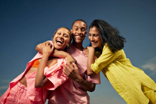 cheerful friends laughing against sky - fashion stock pictures, royalty-free photos & images