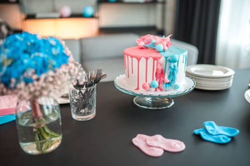 cheerful gender reveal party with beautifully decorated cake - home decoration stock pictures, royalty-free photos & images