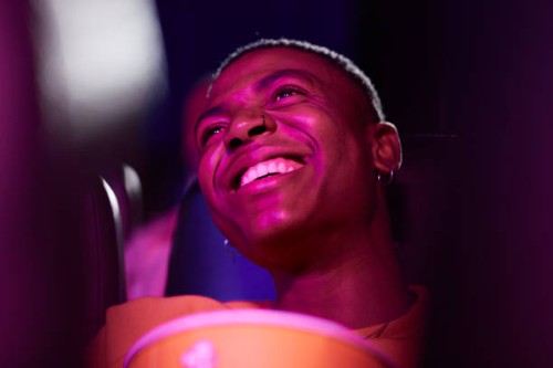 cheerful man at movie theater - fashion stock pictures, royalty-free photos & images