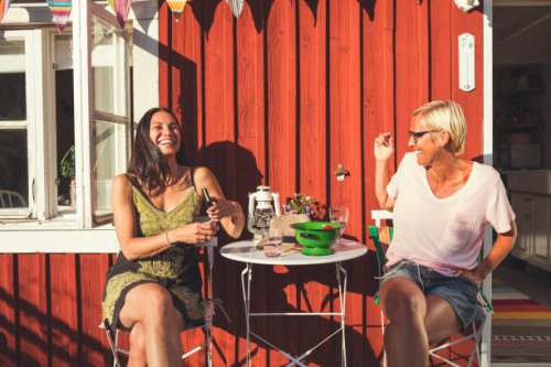 cheerful mature female friends enjoying summer in back yard on sunny day - garden decoration stock pictures, royalty-free photos & images