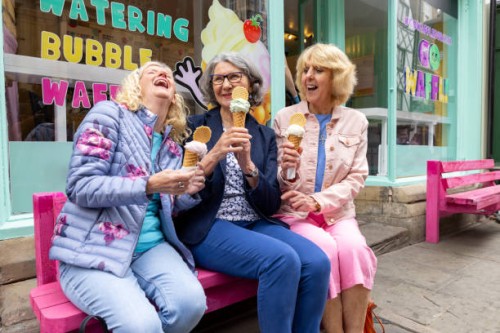 cheerful mature woman eating ice cream together - junk food stock pictures, royalty-free photos & images